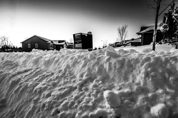 Residential mailbox blocked by a snow pile left by a plow after clearing a street. High quality photo