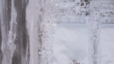 Aerial drone view overhead of a residential road with snow banks. High quality 4k footage