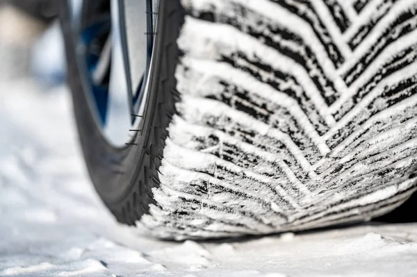Closeup selective focus on snow packed in an all-weather tire tread. High quality photo