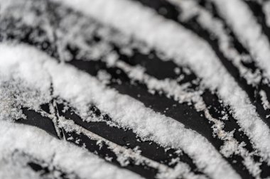 Tüm hava koşulları altında paketlenmiş kar üzerine yakın çekim odaklı lastik izi. Yüksek kalite fotoğraf