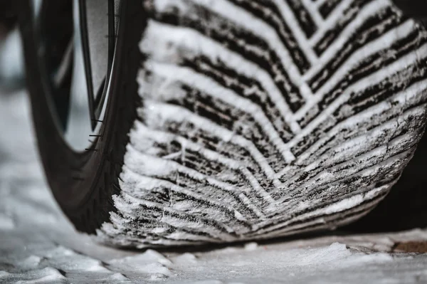 Closeup selective focus on snow packed in an all-weather tire tread. High quality photo
