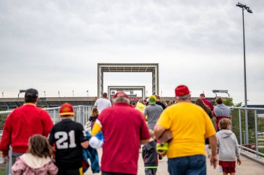 Ames, Iowa, USA - 9.2022 - Fans walking across the Lincoln Way elevated bridge from the tailgating lots to Jack Trice Stadium. High quality photo clipart