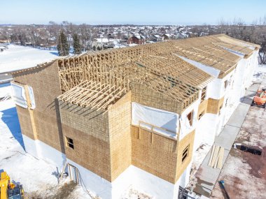 Aerial drone view of a multifamily apartment complex under construction. High quality photo