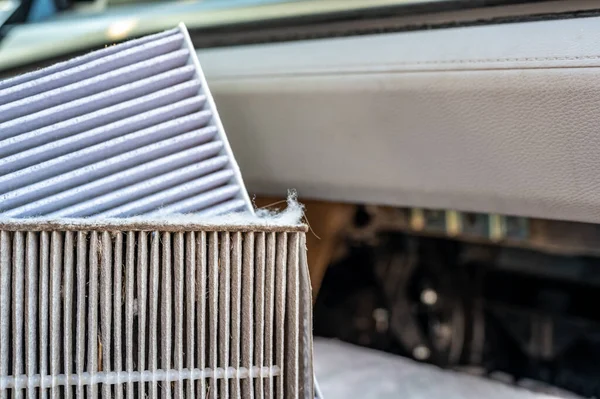 Side-by-side comparison of a dirty and clean automotive cabin filter. High quality photo