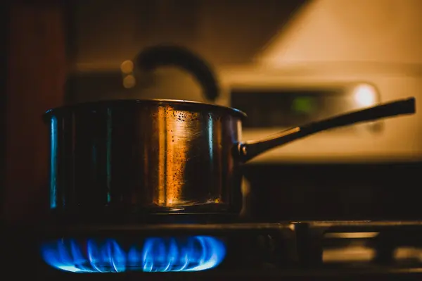 Natural gas burner at a cabin kitchen heating up a metal pot. High quality photo