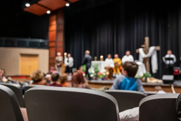 defocused Christian church service with Cross on stage. High quality photo
