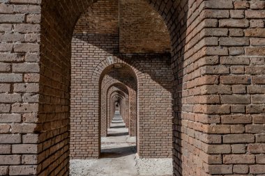 Endless brick passage with repeating archways in Fort Jefferson on Dry Tortugas National Park. High quality photo clipart