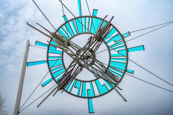 Scottsdale, Arizona, USA - 3.23.2024: Sunburst sculpture of stainless steel, laminated dichroic glass, and painted carbon steel. High quality photo