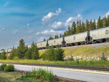 Banff, Alberta - 8.13.2024: Canadian Pacific rail cars moving down a track. High quality photo clipart