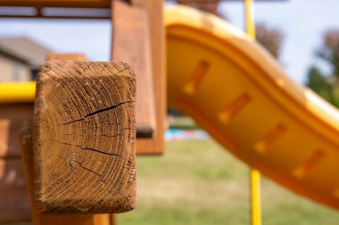 Cracked and weathered end grain wood on an outdoor playset . High quality photo clipart