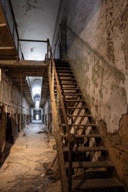 decrepit cell block and stairs leading to upper level at Eastern State Penitentiary historic site. High quality photo clipart