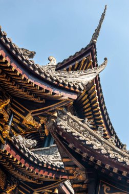 Traditional Chinese architecture details against clear blue sky in BaoLunSi temple Chongqing, China