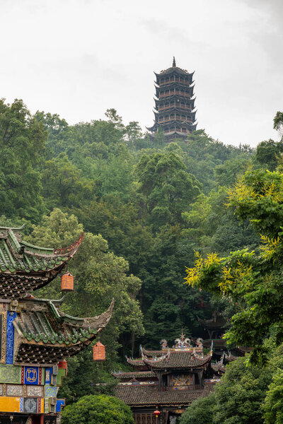 Nestled in the heart of DuJiangYan, Sichuan province, this vibrant location showcases traditional architecture harmonizing with nature. Graceful pagodas and intricately designed rooftops rise from the