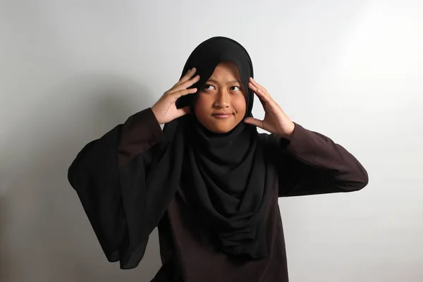 진지하게 히잡이나 스카프를 아시아 소녀가 배경에 고립된 생각하면서 머리를 움켜쥐고 — 스톡 사진