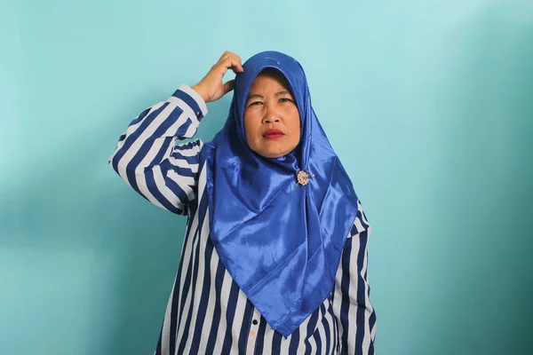 Zmieszana Azjatka Średnim Wieku Niebieskim Hidżabie Koszuli Paski Patrzy Kamerę — Zdjęcie stockowe