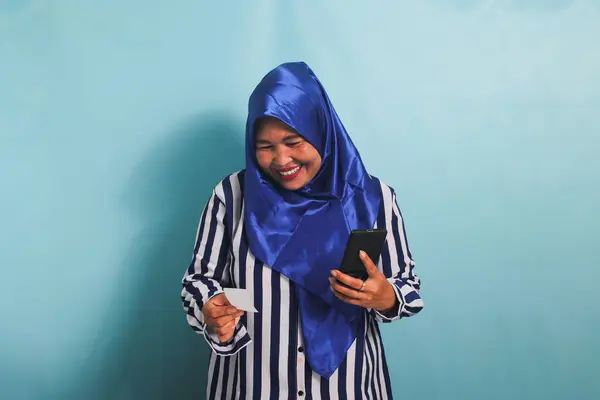 Smiling Middle Aged Asian Woman Blue Hijab Striped Shirt Holding — Stock Photo, Image
