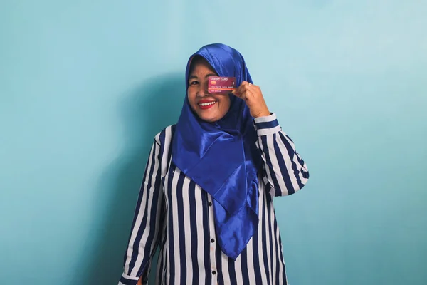 Podekscytowana Azjatka Średnim Wieku Niebieskim Hidżabie Koszulce Paski Prezentująca Kartę — Zdjęcie stockowe