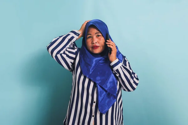 Zszokowana Azjatka Średnim Wieku Niebieskim Hidżabie Koszuli Paski Rozmawia Przez — Zdjęcie stockowe