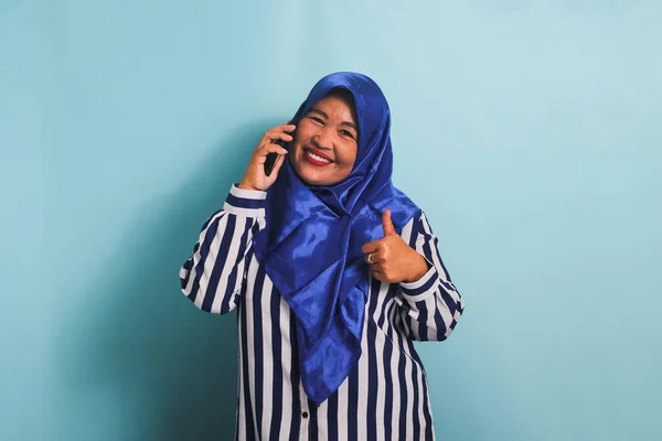 Cheerful Middle Aged Asian Woman Blue Hijab Striped Shirt Giving — Stock Photo, Image