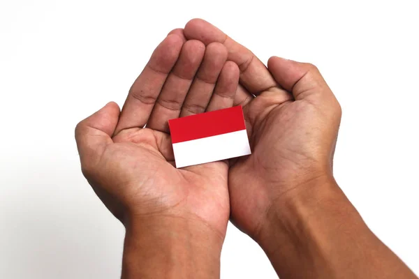 Tangan Memegang Bendera Indonesia Dengan Ruang Salinan Kosong Yang Terisolasi — Stok Foto