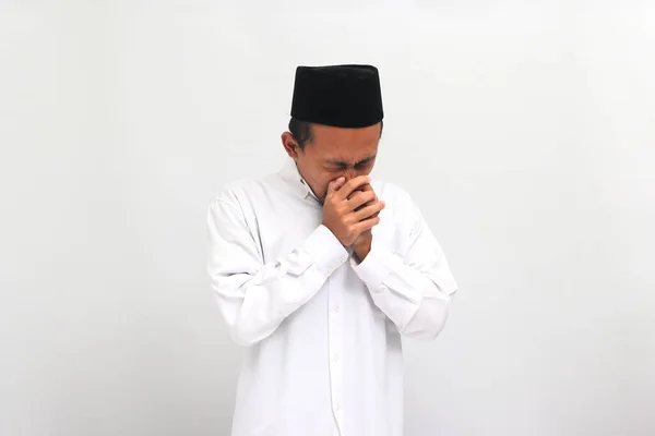 若いインドネシア人男性は ソングコックやピッチ またはコピアを着用し 白い背景に孤立した熱とインフルエンザに苦しんでくしゃみしています — ストック写真