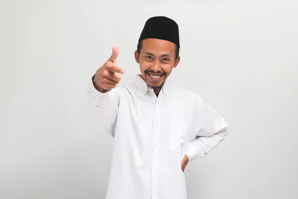 有自信的印度尼西亚年轻人 身穿歌舞 山核桃或Kopiah 用手指对着摄像机笑着 邀请人或招募 这些人都是在白色背景下被隔离的 — 图库照片