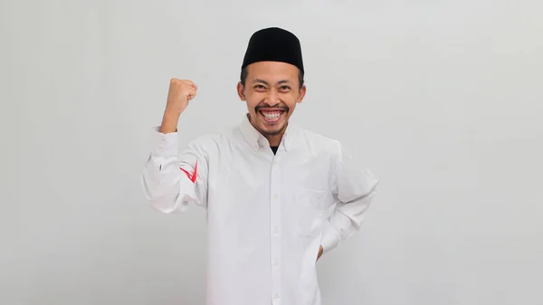 8月17日 印度尼西亚独立日 一名身穿歌舞 山核桃或Kopiah的年轻男子在庆祝独立日的时候骄傲地举起了拳头 他与白人隔离在一起 — 图库照片