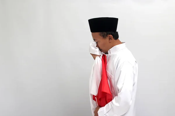 8月17日にインドネシア独立記念日を祝いながら インドネシアの国旗を敬意の象徴としてキスしているインドネシアの若いインドネシア人男性 — ストック写真