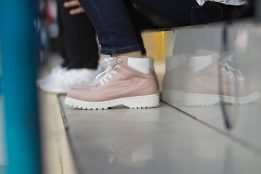 Sokakta spor ayakkabılı şık bir kadının ayaklarına yakından bakın.