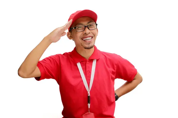 stock image Excited Indonesian delivery man or courier celebrating Indonesian Independence Day by making a salute gesture. Isolated on a white background