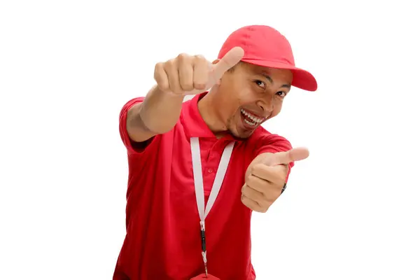 stock image Excited Asian Delivery man or courier is showing thumb up gesture at the camera, Isolated on a white background