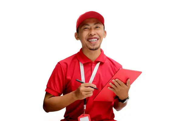 stock image Confident Asian delivery man, courier, or warehouse worker holds a tablet, Isolated on a white background, Concepts of inventory management, logistics and delivery services.