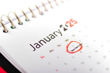 Ocak 2025 tarihli takvim sayfasındaki yakın plan, ayın ilk günü, 1 Ocak, kırmızı ve etiketli 