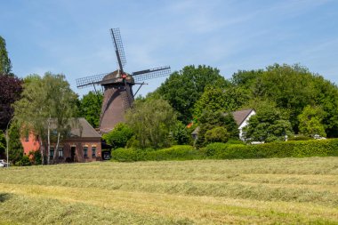 The old windmill. A beautiful summer day in Neukirchen Vluyn. Not far from Moers, Germany clipart