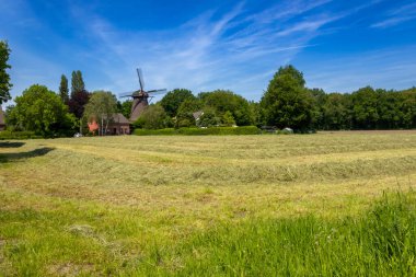 The old windmill. A beautiful summer day in Neukirchen Vluyn. Not far from Moers, Germany clipart