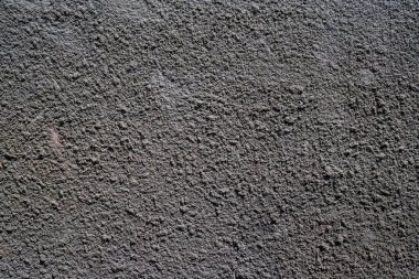 Gri, beton bir duvar ve belirgin bir tahıl gevşemesi. Yüksek kalite fotoğraf