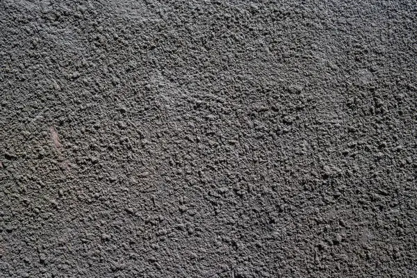 Gri, beton bir duvar ve belirgin bir tahıl gevşemesi. Yüksek kalite fotoğraf