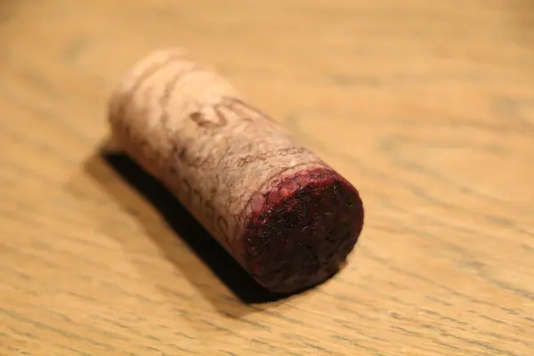 a natural wine cork with little cork bleed of red wine