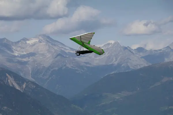 stock image hang glider in the air with a backdrop of a blue mountain ridge