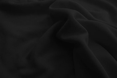 Soyut siyah dalgalı kumaş. Koyu renk kumaş arkaplan.