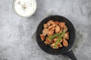 Greek gyros in a frying pan on a gray background. High quality photo