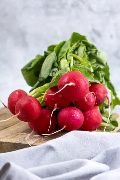 stock image Fresh bunch of radish on wooden table, vertical photo. High quality photo