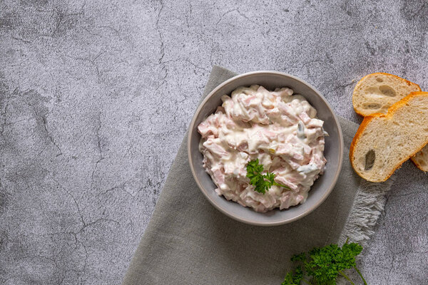 Meat salad with mayonnaise and cucumbersin a bowl. Udder salad. High quality photo