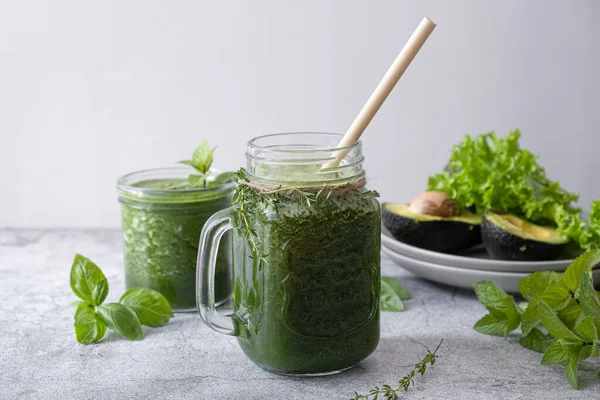 Blended green smoothie with ingredients. Healthy smoothie. High quality photo