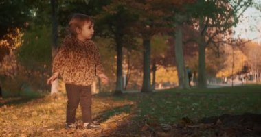Anne ve kız bebek sonbaharda açık havayı keşfediyorlar. 4K gerçek hayat, gizli kamera görüntüleri. 4K RAW 'da bir sinema kamerasında çekildi..