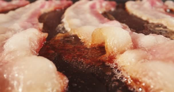 Closeup Slider Shot Fresh Bacon Frying Griddle Cinematic Footage — Stock Video