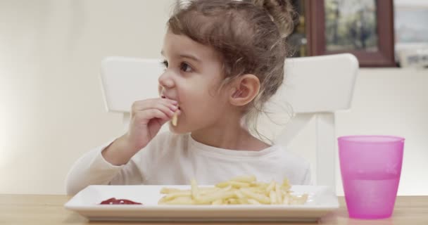 Cute Toddler Girl Eating French Fries Cinematic Footage — Stock Video