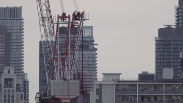 Urban Development Cinematic Footage Capturing Crane Constructing Modern Condo Bustling — Stock Video