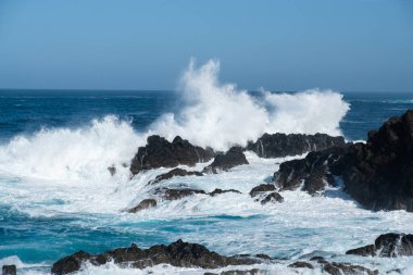 ocean waves crashing on rocks ,windy weather