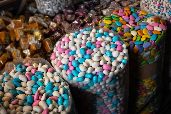 Bags of sweets, pile of coated almonds